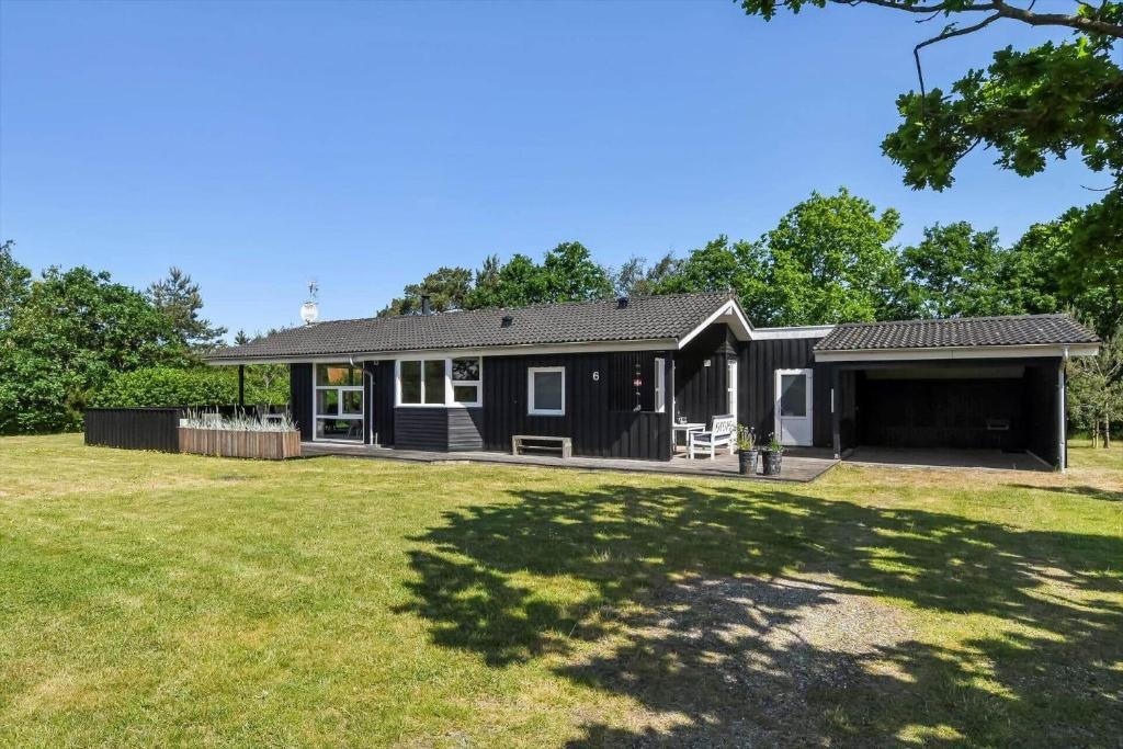 a black house with a yard at C11333-Tarm-Laksestien-6 in Tarm