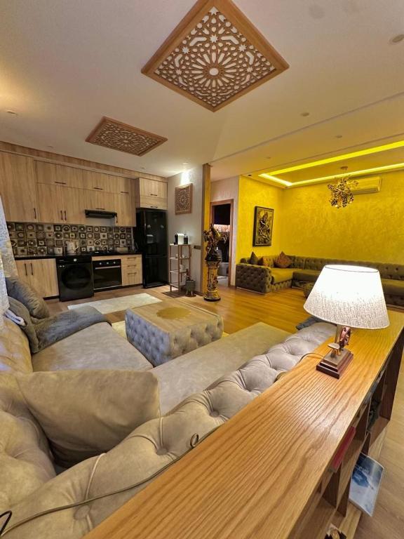 a large living room with a couch and a table at Raoufff allam in Kenitra