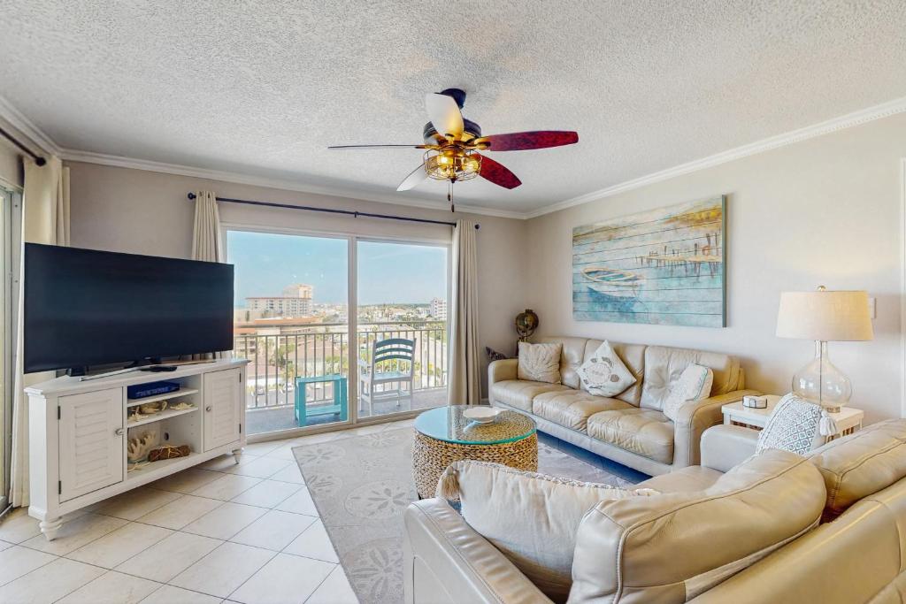 a living room with a couch and a flat screen tv at Anglers Cove 608 in St. Pete Beach