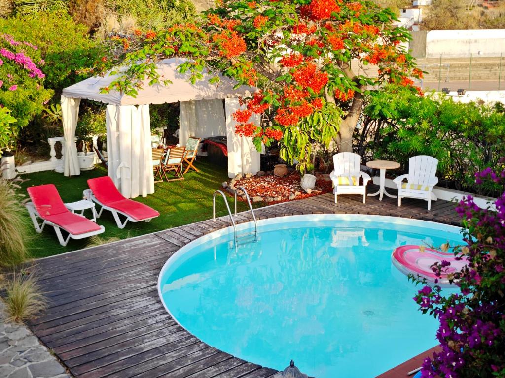 a backyard with a swimming pool and a gazebo at Modern Panoramic Villa with Pool & Terrace in Puerto de la Cruz