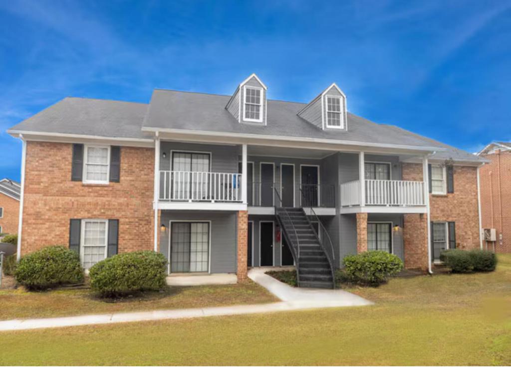 a brick house with a staircase in front of it at Beaumont Reserve Montgomery in Montgomery