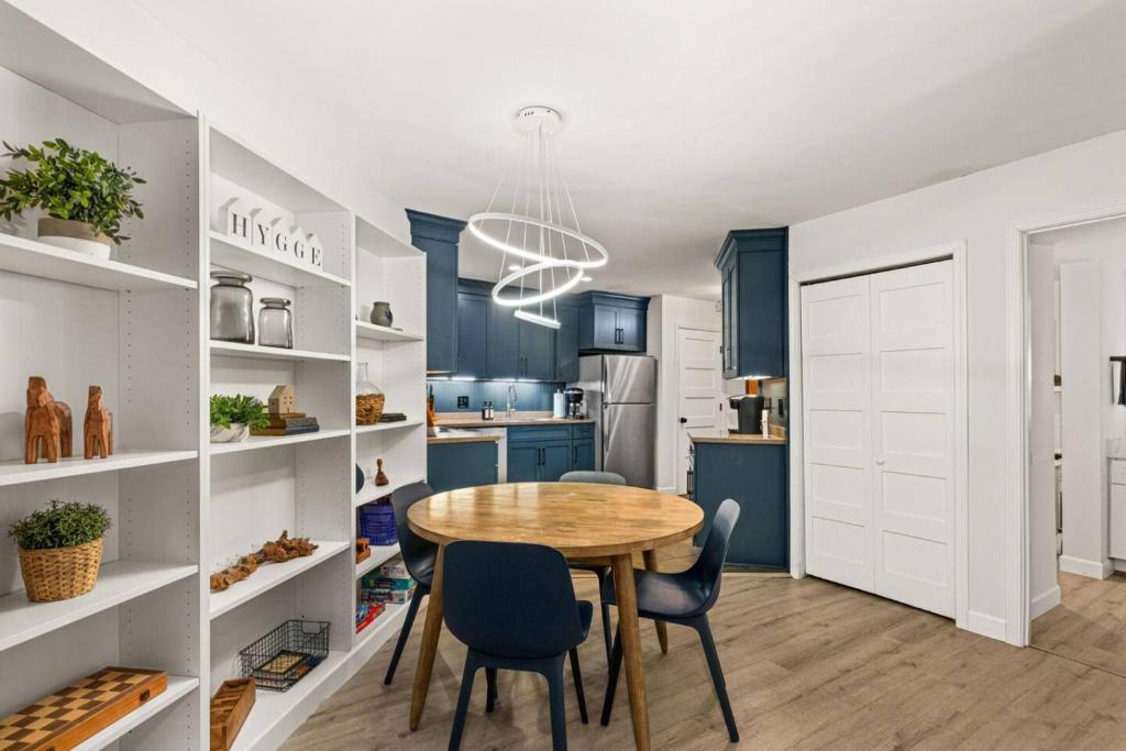 a kitchen and dining room with a table and chairs at Fully updated condo ski in ski out hot tub pool in Lutsen