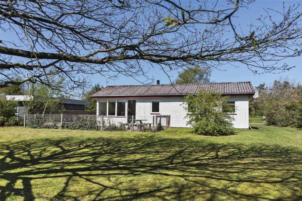a white house with a fence and a yard at C11306-Tarm-Hjortevej-10 in Tarm