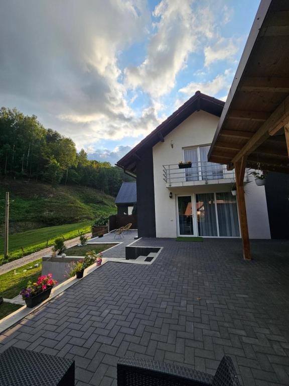 a home with a patio and a house at Vibe House Madisson in Braşov