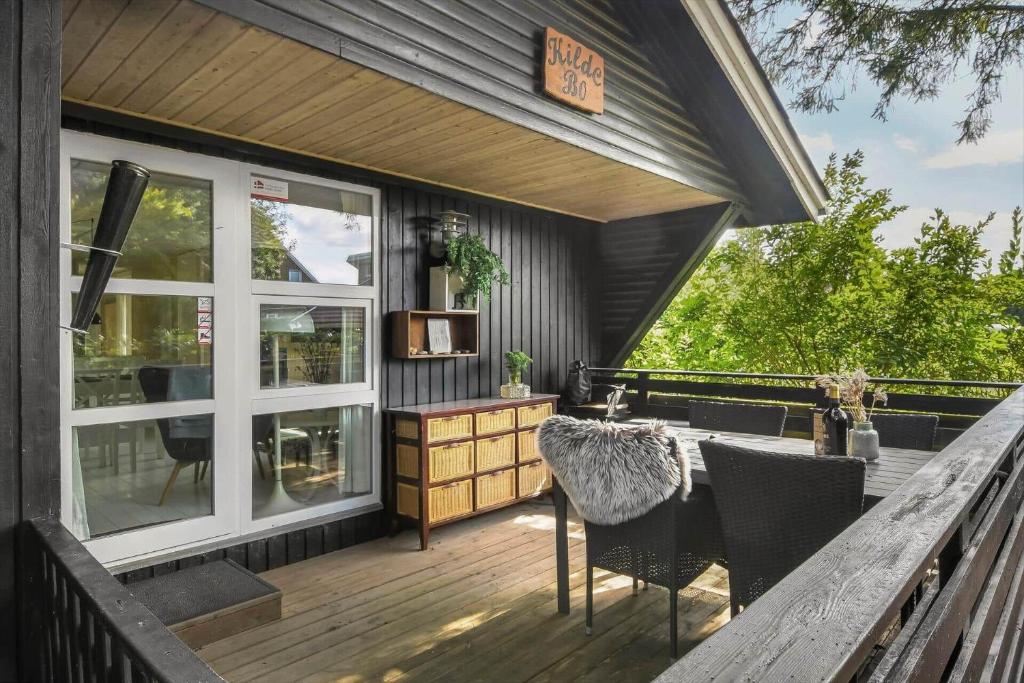 a deck with a table and chairs on a house at C11678-Hemmet-Bork-Hytteby-248 in Hemmet