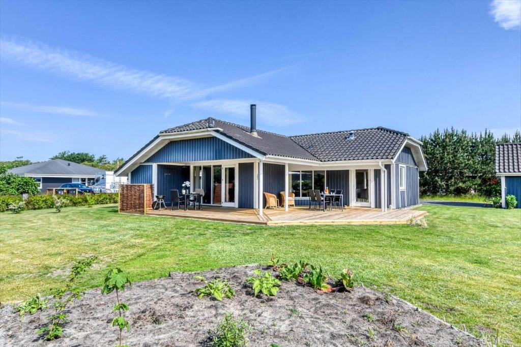 a house with a large yard with a deck at C11324-Tarm-Blabaervej-6 in Tarm