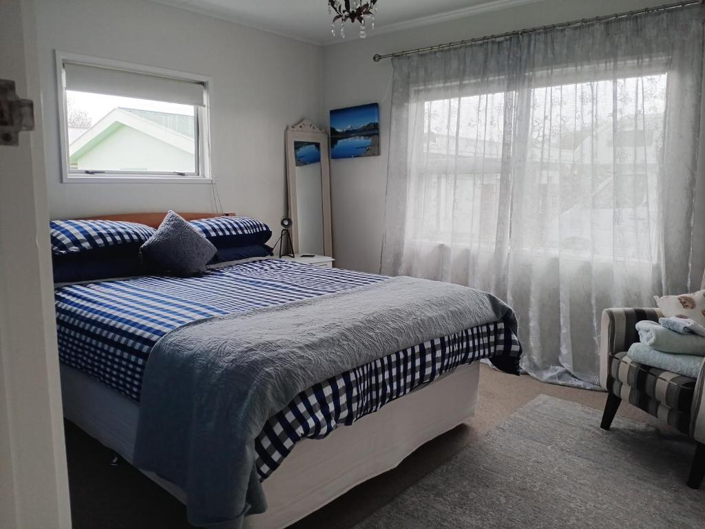 a bedroom with a bed and a window at Three Doors Whole 3bdr Home Central Motueka in Motueka