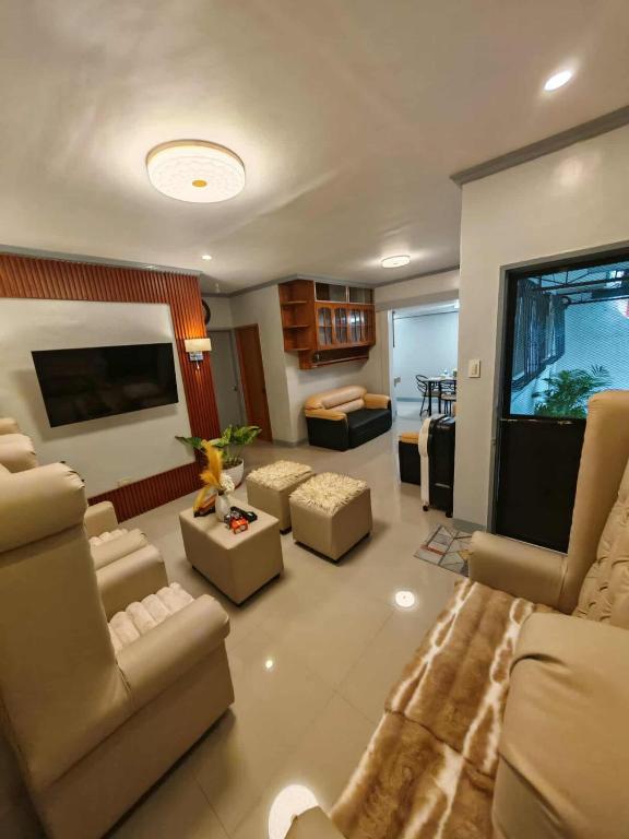 a large living room with couches and a television at Grace Abode Haven in General Santos