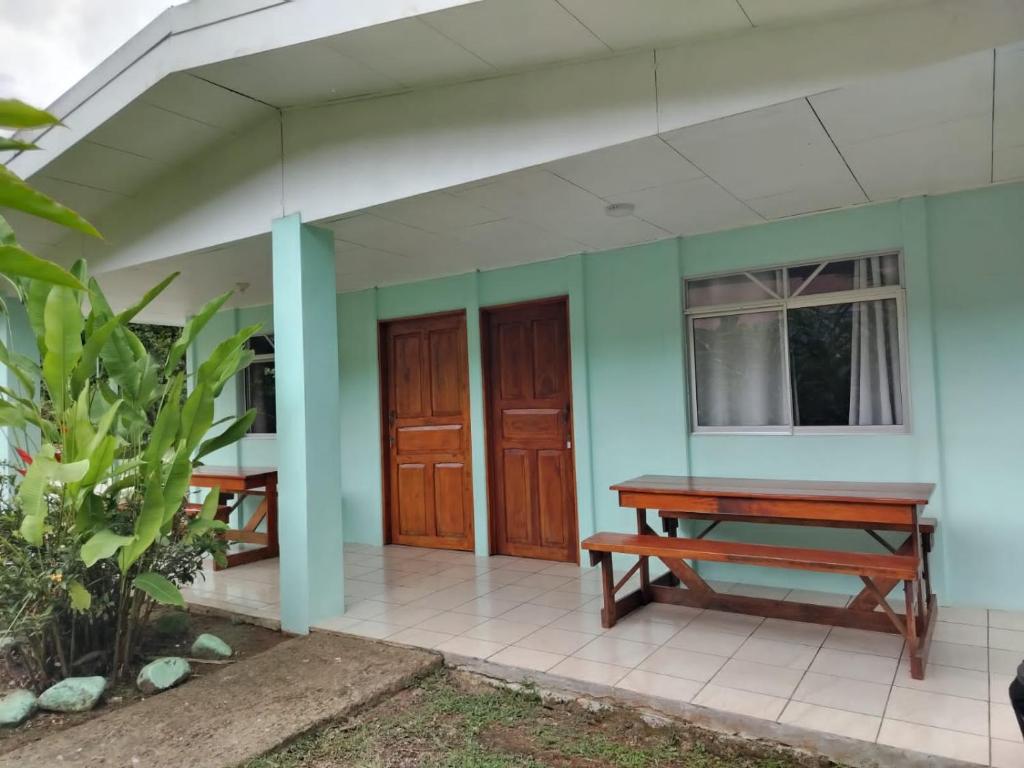 a front porch of a house with a bench at Cabinas Hidalgo in Ojochal