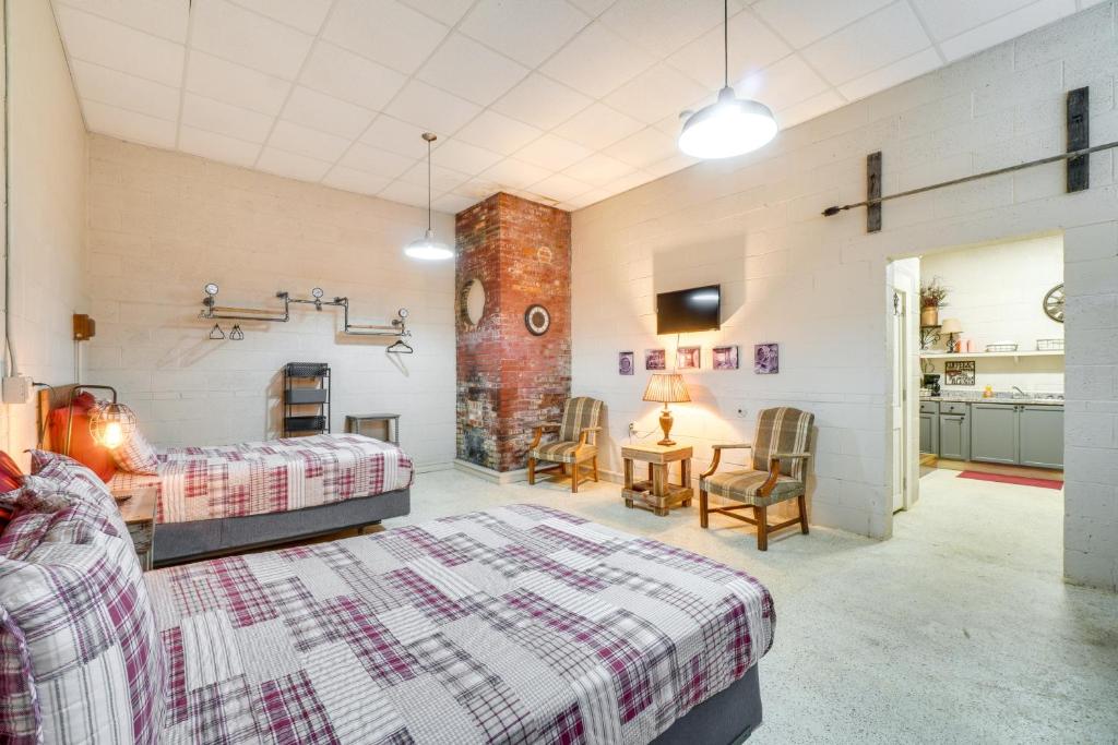 a bedroom with a bed and a table and chairs at The Boiler Room - ATV-Friendly Briceville Gem! in Briceville