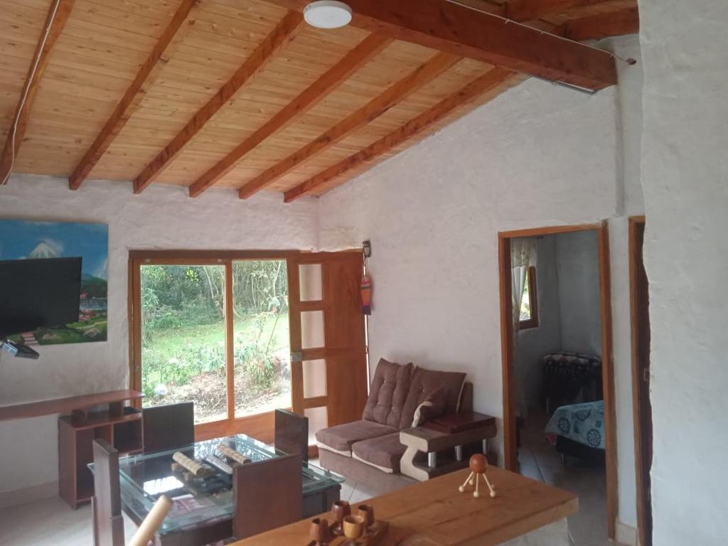 a living room with a couch and a table at Cabaña campestre in Medellín