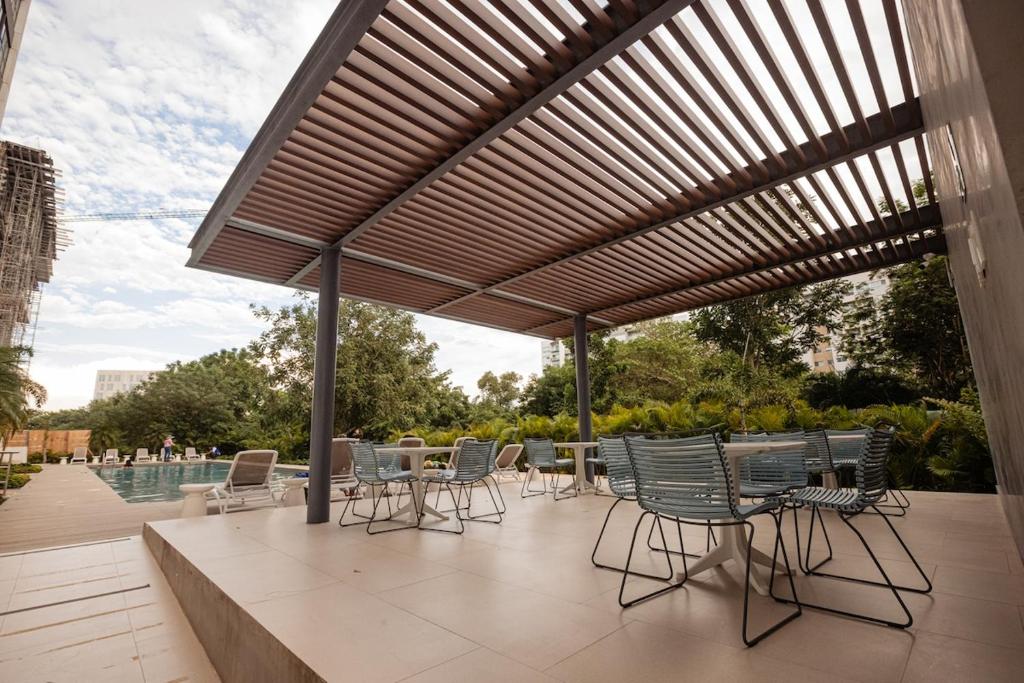 a patio with a table and chairs under awning at Indico in Mérida