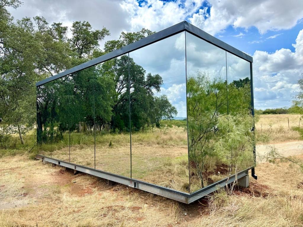a glass container with a plant in it in a field at Perseus at The Retreat in Fredericksburg