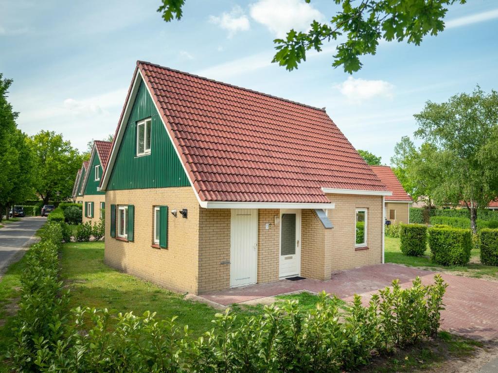 a house with a green roof at Brabant Holiday Home With Sauna 