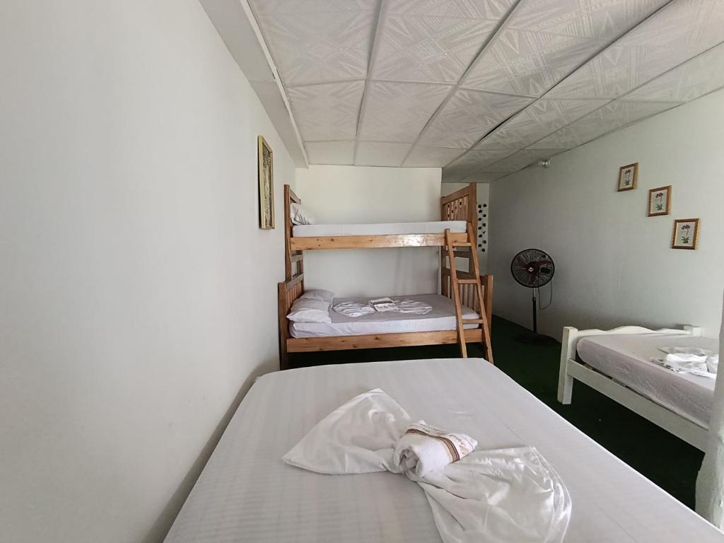 En eller flere senge i et værelse på Hotel Los Chamos Barú