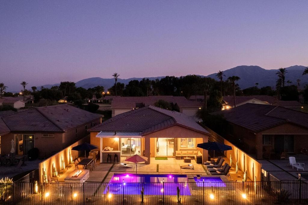 an aerial view of a house at night with lights at NEW Sunset Palms, AC Gameroom, Pool, Spa, EV charger in Indio