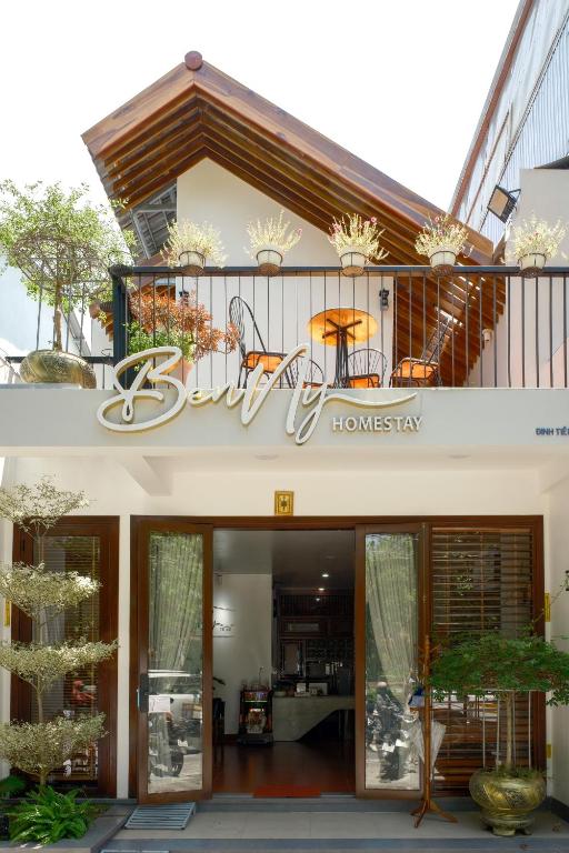 a building with a sign on the front of it at Benny Homestay Huế in Hue