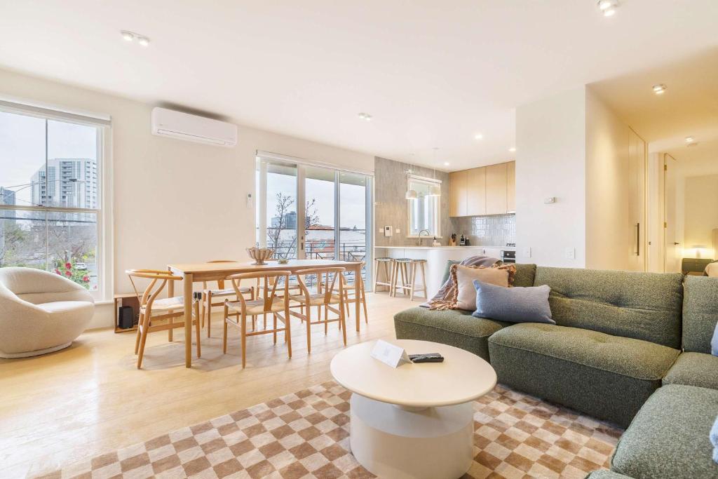 a living room with a couch and a table at Stylish Spacious Apartment in Malvern in Melbourne