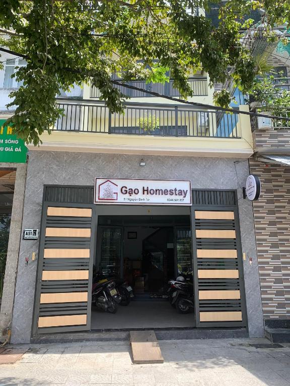 a store with two garage doors with motorcycles inside at Gạo Homestay-Hue in Hue