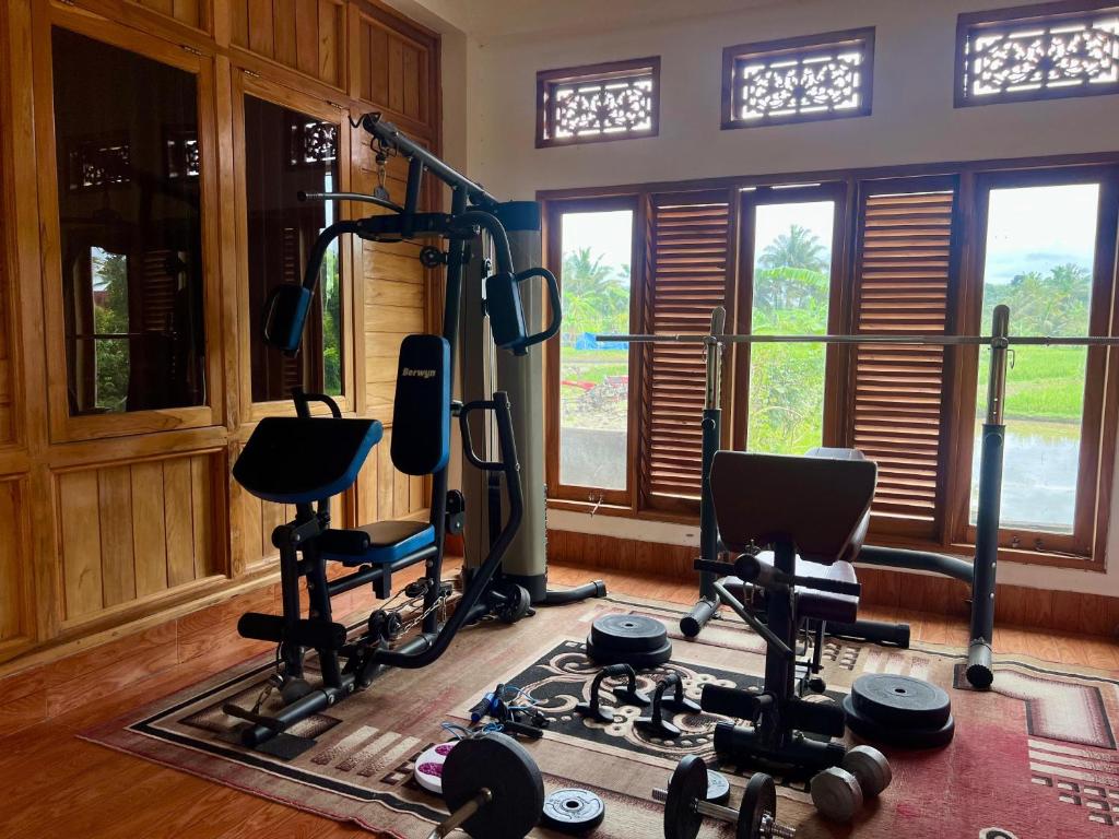 a gym with several exercise equipment in a room at 361 Terrace Bungalows in Rarang