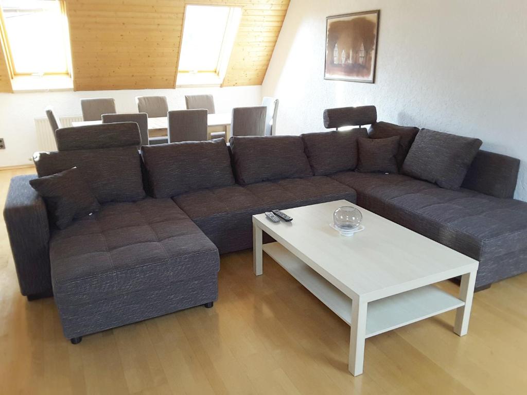 a living room with a couch and a table at KRIO Nicola Rothfuchs Ferienwohnung 2 in Idar-Oberstein