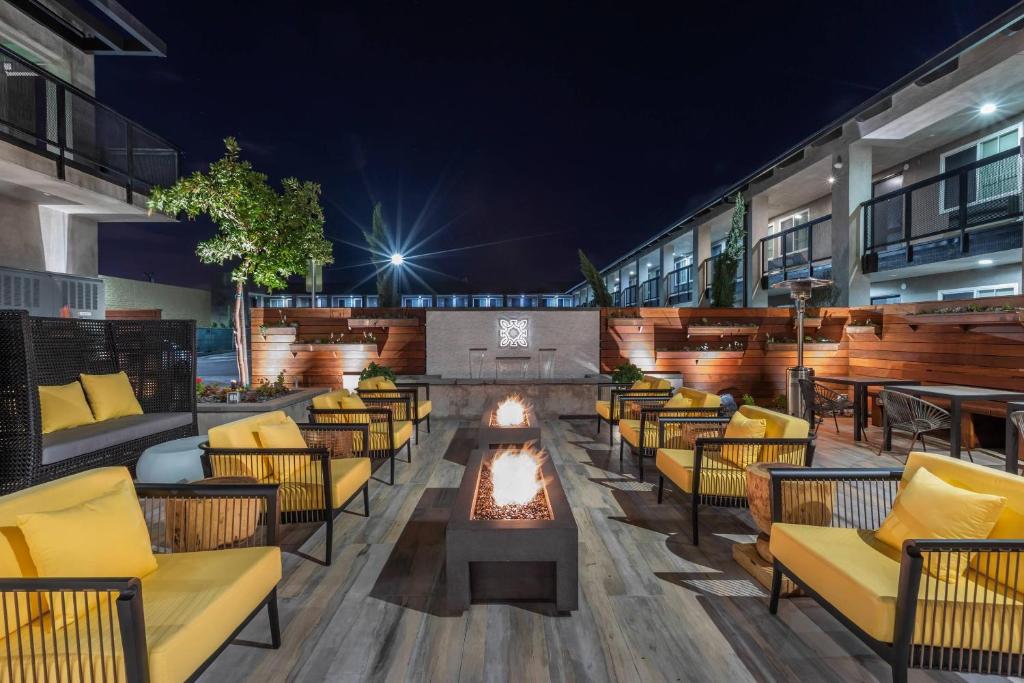 a bar with couches and a fire pit at night at Bluestem Hotel Torrance Los Angeles, an Ascend Collection Hotel in Torrance