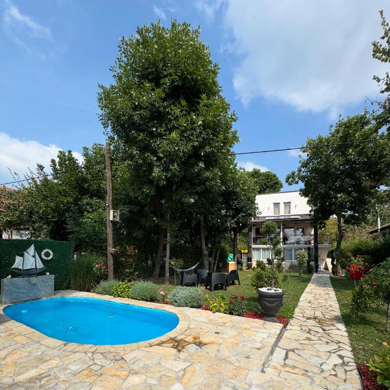 a swimming pool in a yard with a landscaping at Dunavska lepotica 2 in Belgrade