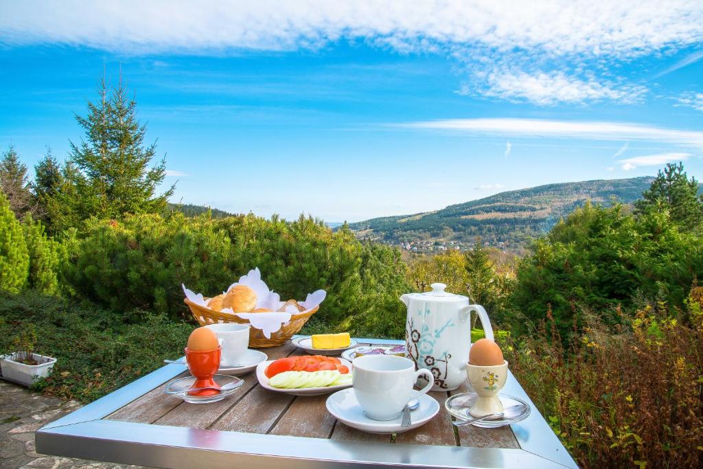 a table with a breakfast of coffee and fruit on it at DW Averon in Świeradów-Zdrój