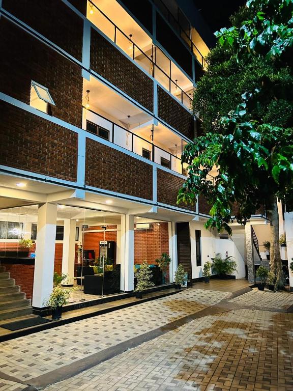 a brick building with a courtyard in front of it at Unic Residence And Transit Hotel in Katunayake