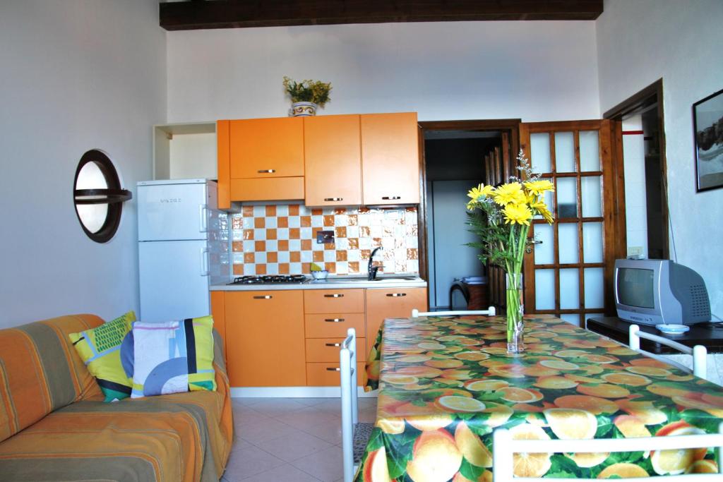 a kitchen with a table with a vase of flowers on it at Casa Unci in Canneto