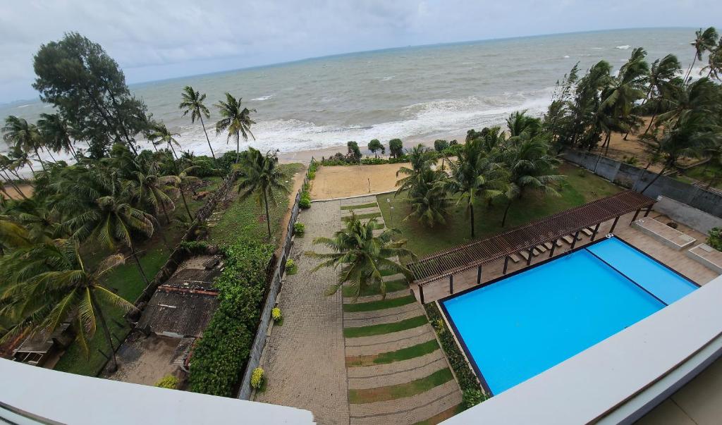 an ocean view from the balcony of a resort with a swimming pool at Beach Front Apartment 1 in Bopitiya