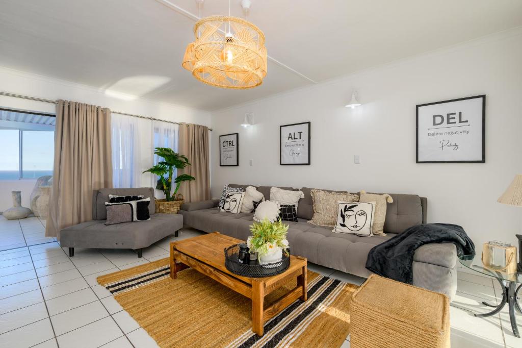 a living room with a couch and a table at 9 Manaba Dax in Margate