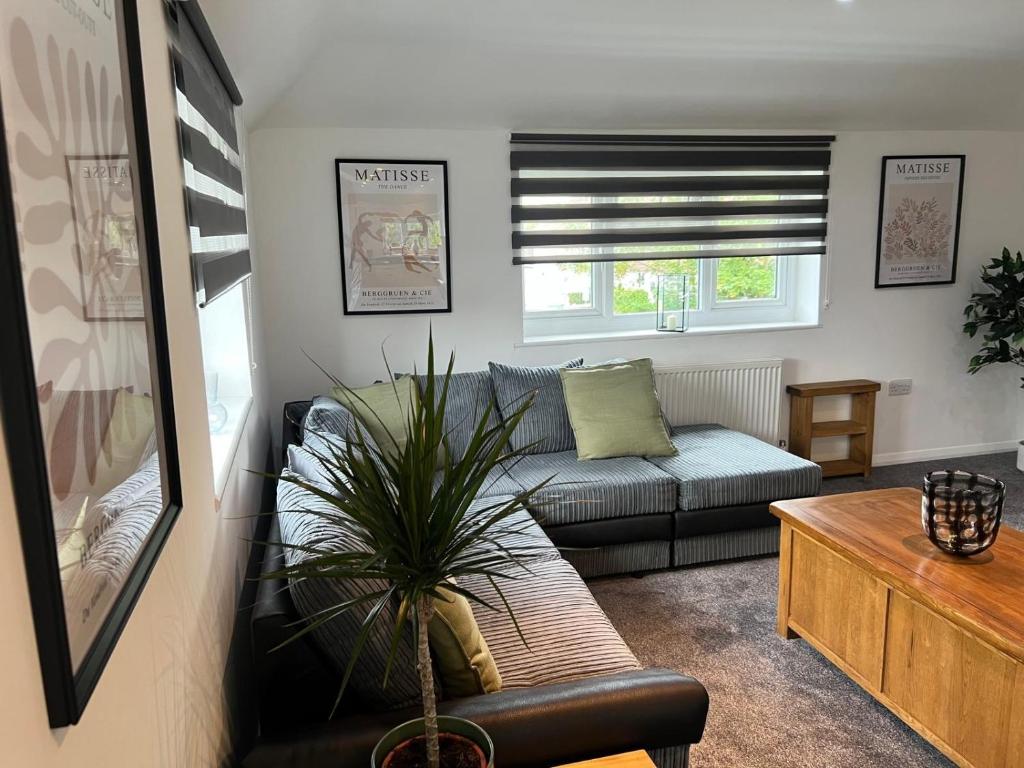 a living room with a couch and a table at Gatwick 2 Bed Apartment 4 in Horley