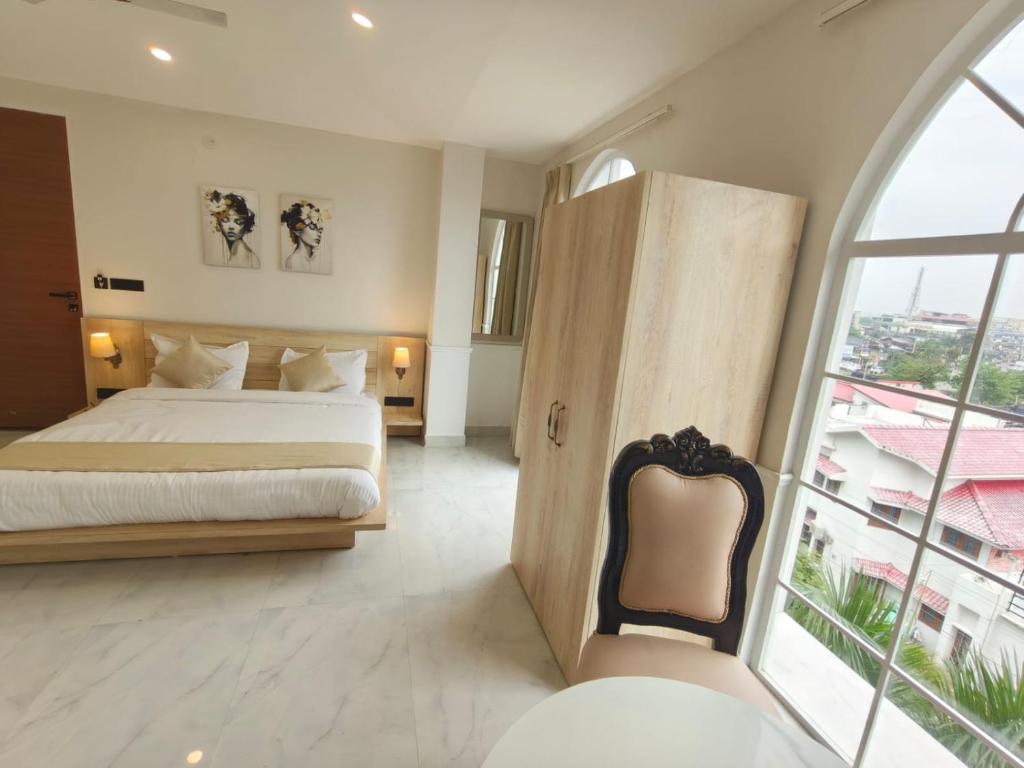 Postel nebo postele na pokoji v ubytování Hotel Y J Manor