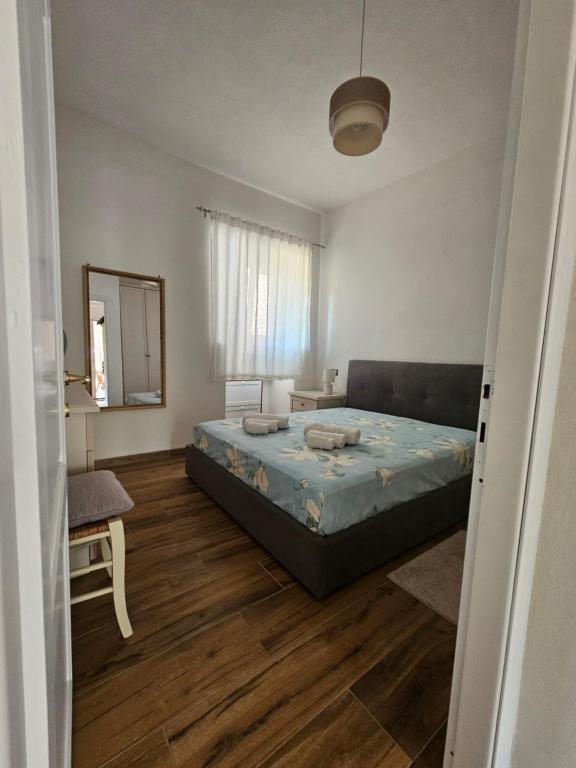 a bedroom with a bed and a mirror in it at Villa S'Olia in Villa Gorizia