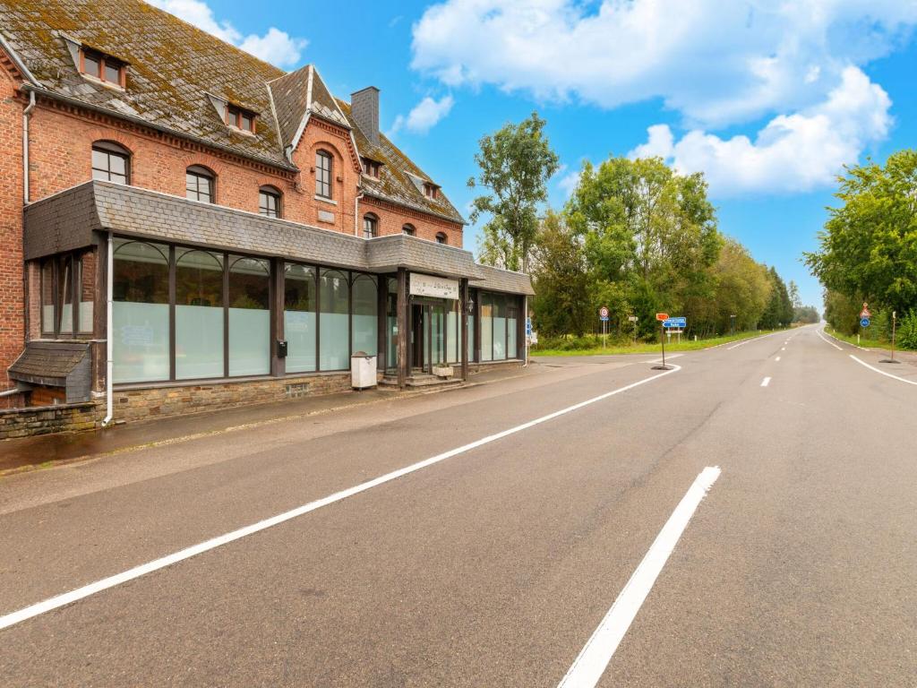 an empty road in front of a brick building at Grand Ardennes Retreat in Xhoffraix