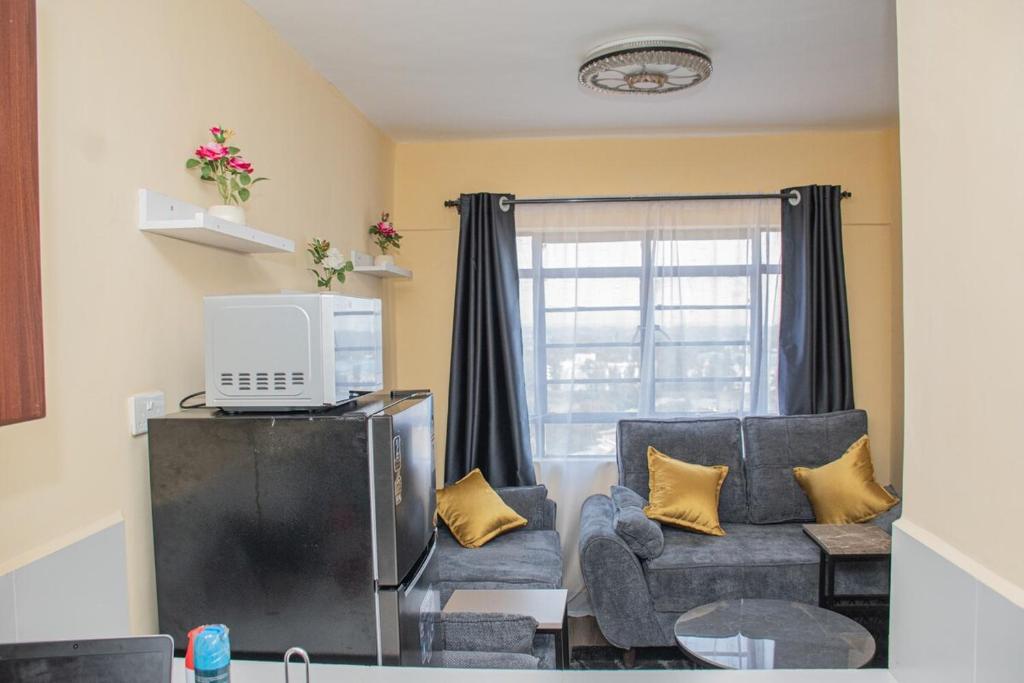 a living room with a couch and a tv at Ordercity in Kisumu