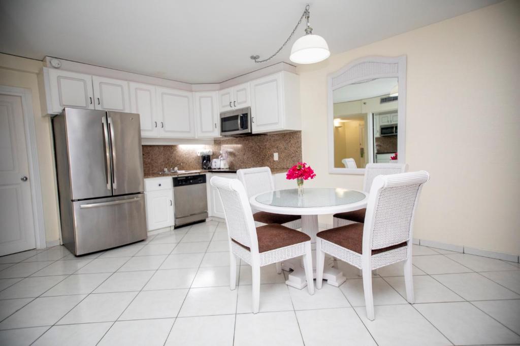 a kitchen with a table and chairs and a refrigerator at Charming apartment in Lowlands with shared pool, 87 m² in Lowlands