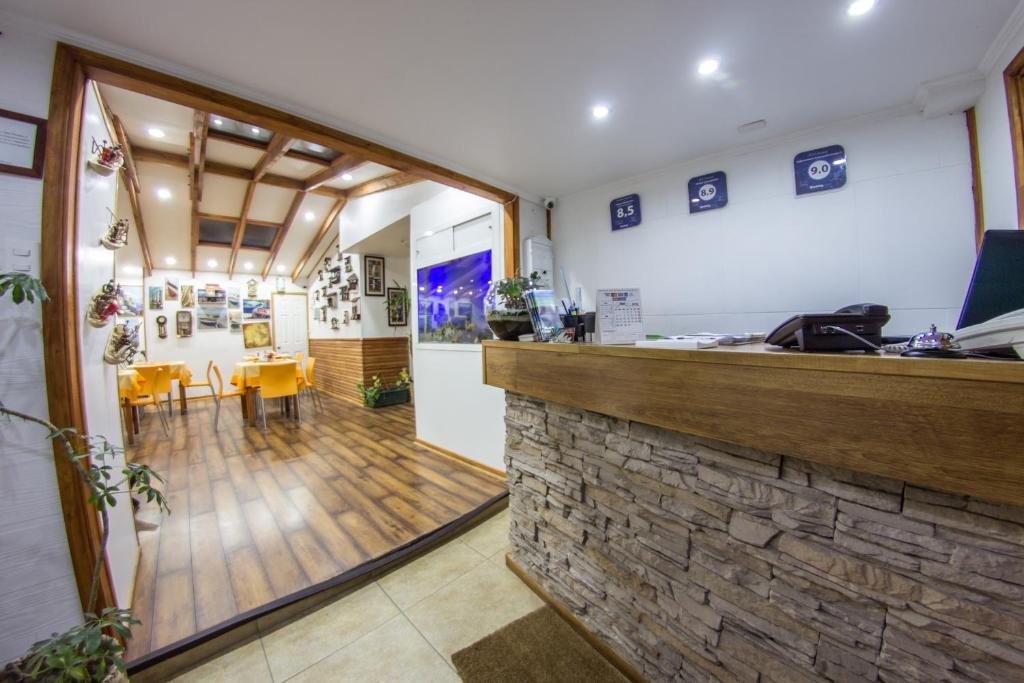 a bar in a restaurant with a stone wall at Hostal Concepcion in Concepción