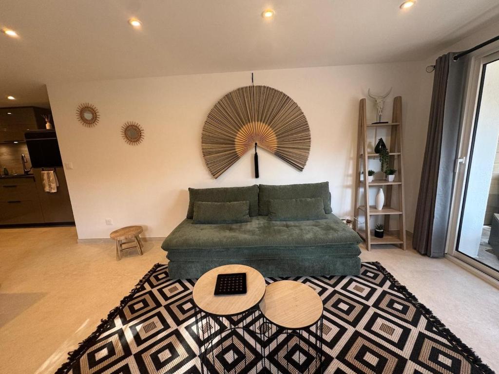 a bedroom with a green bed with two tables at Superbe 2P Terrasse Proche Plage à 2 min in Saint-Raphaël