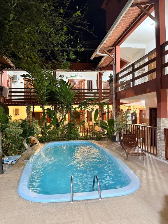 a swimming pool in the middle of a building at Pousada Coqueiro do Caitá in Morro de São Paulo