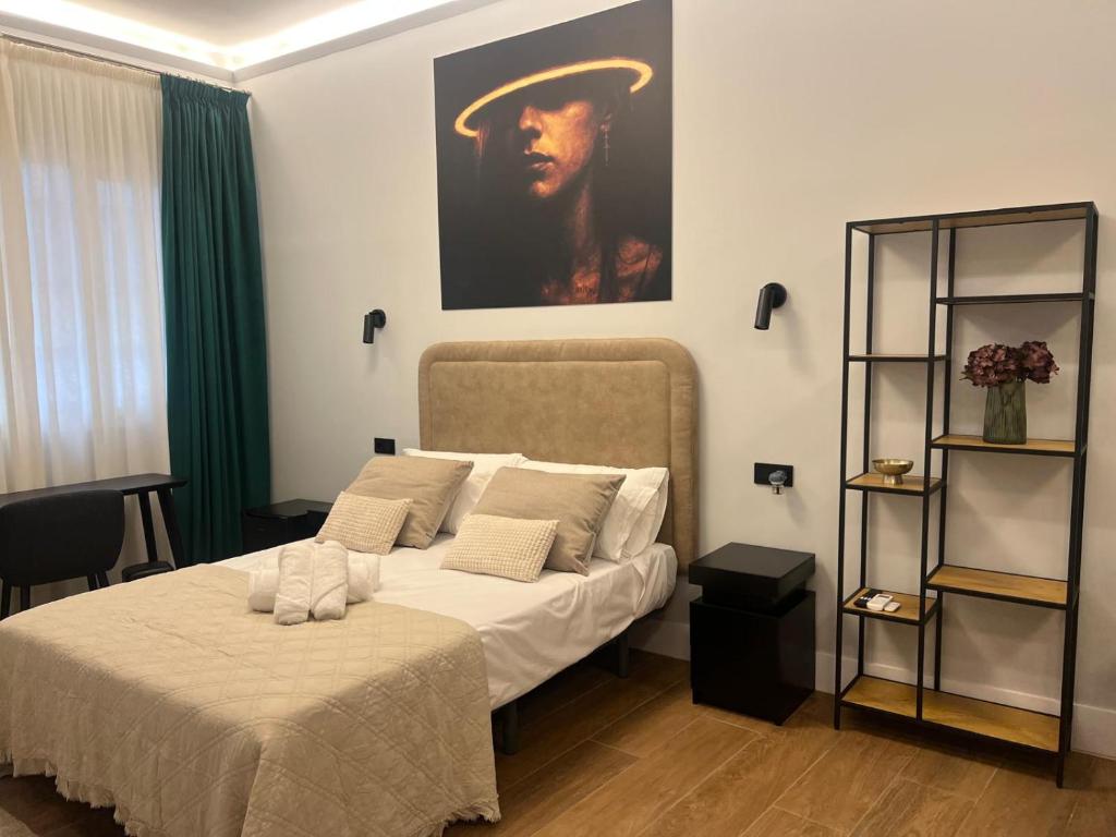 a bedroom with two beds and a painting on the wall at Ventura Luxury in Alicante