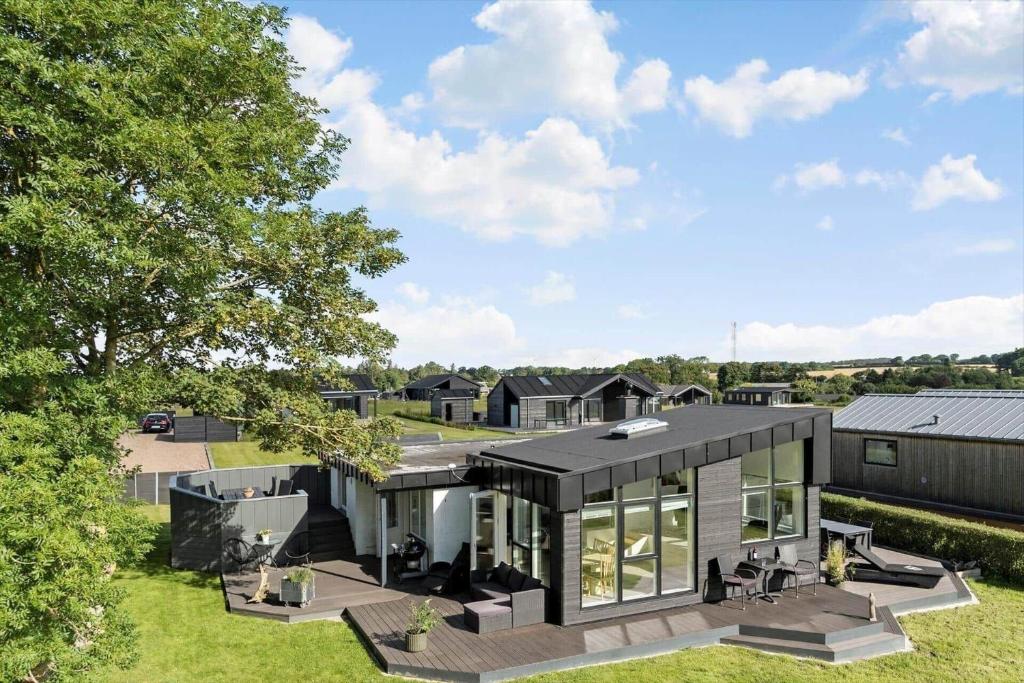 an exterior view of a house with a black roof at SJ236-Haderslev-Blokhusskoven-53 in Haderslev