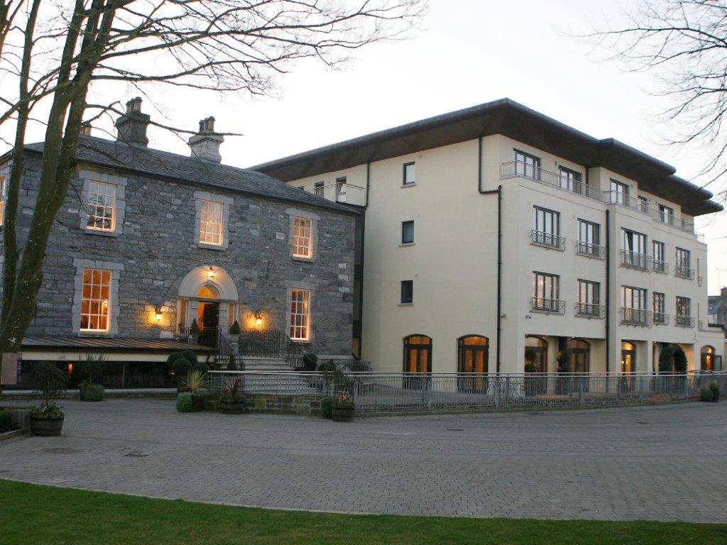 a large stone building with a tree in front of it at Annebrook House Hotel in Mullingar