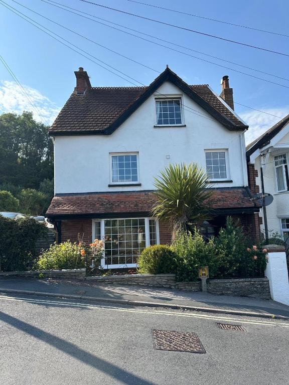 a white house on the side of a street at Lyme Regis Luxury Escape in Lyme Regis