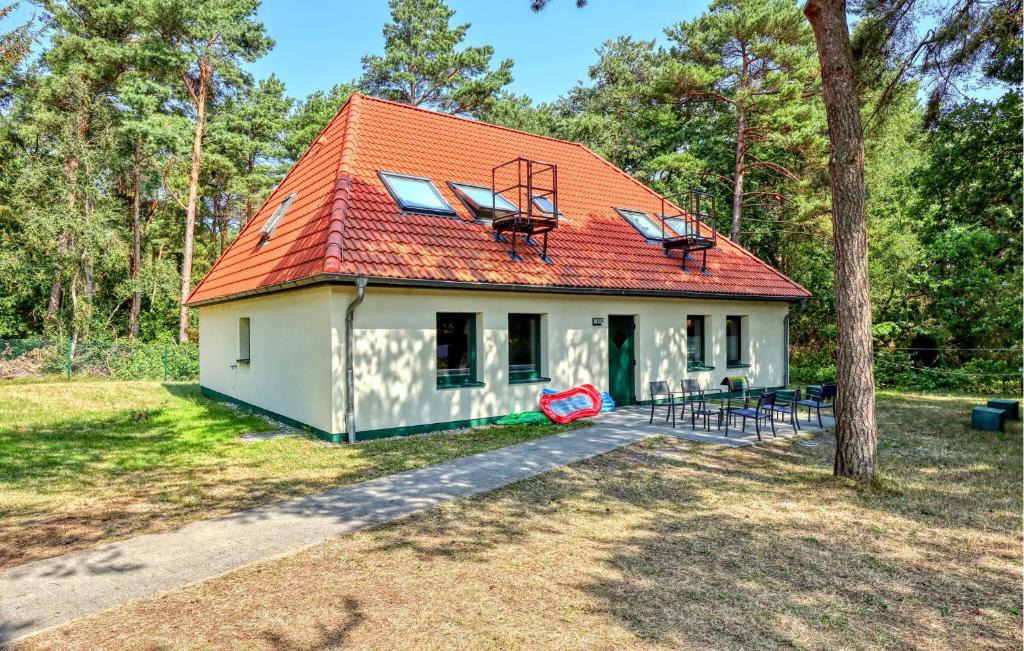 a small white house with an orange roof at Nice Apartment In Altenkirchen in Altenkirchen