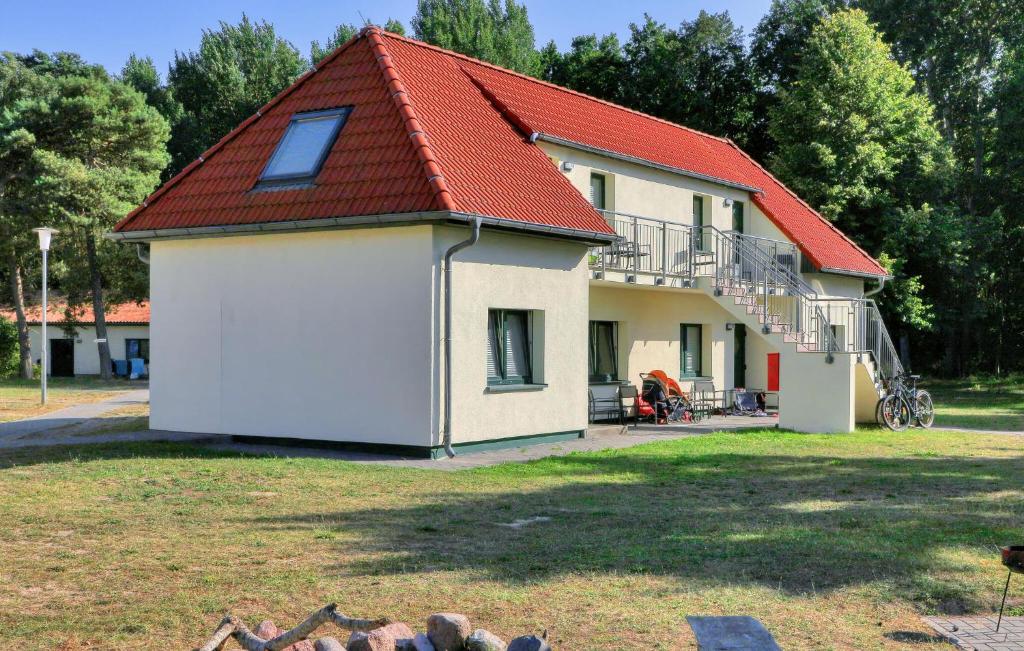 a house with a red roof and a yard at Gorgeous Apartment In Altenkirchen in Altenkirchen