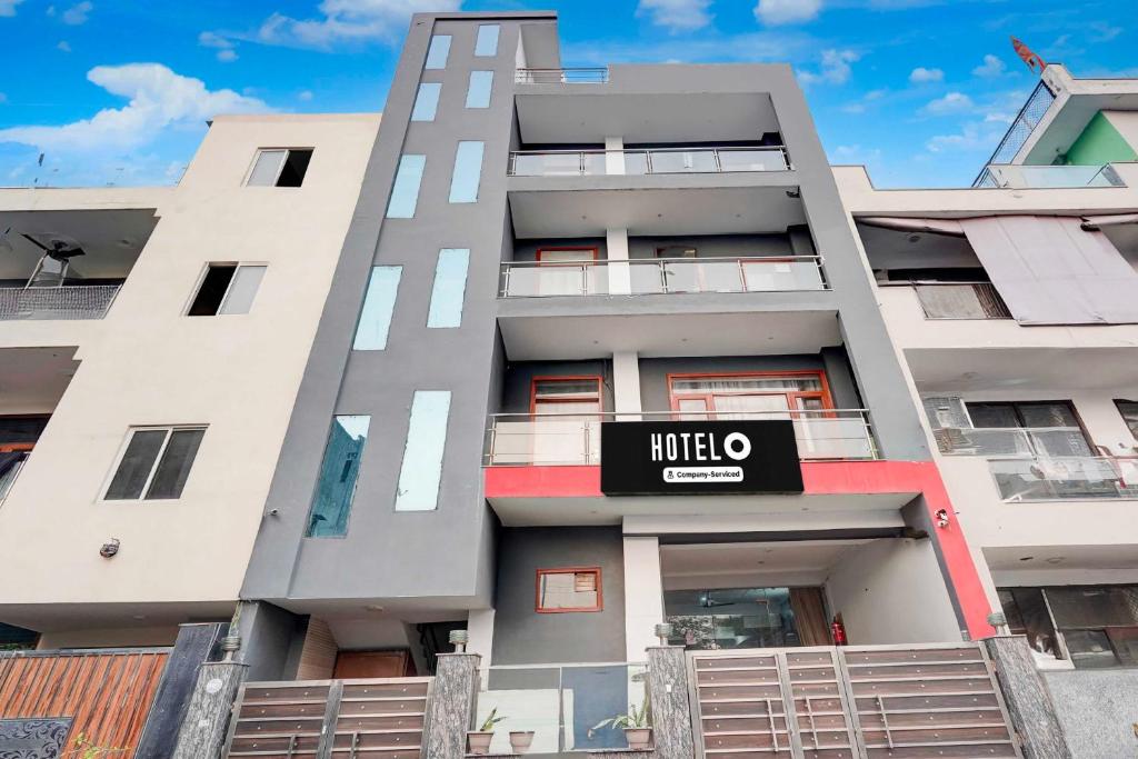 a large apartment building with a hotel sign on it at Hotel O Sector 20 Noida in Noida