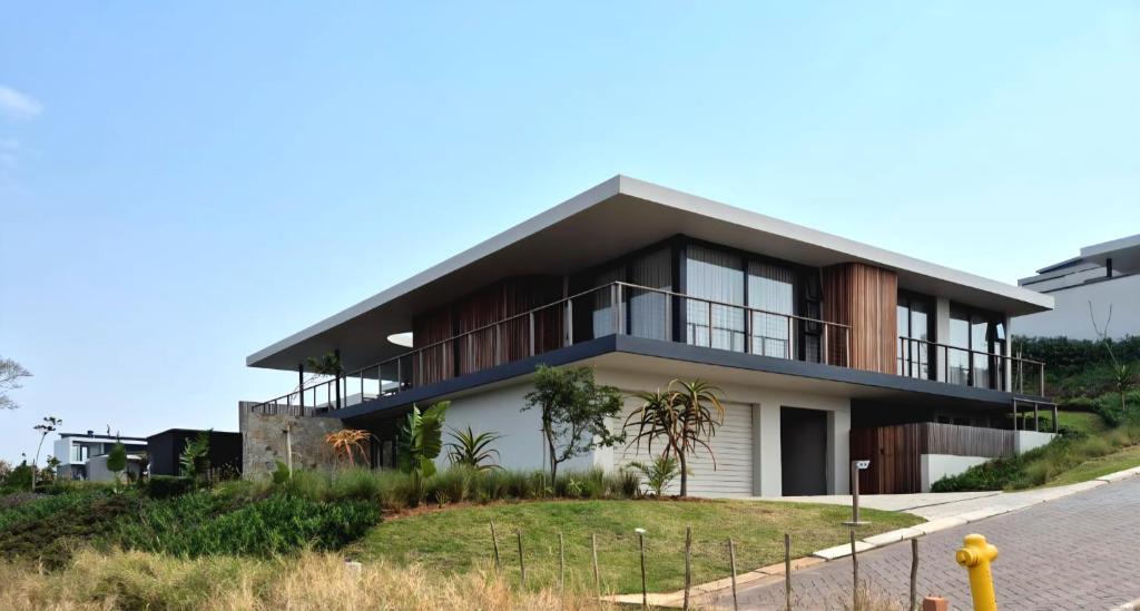 a house on the side of a hill at Modern Luxury Beach Villa in Ballito