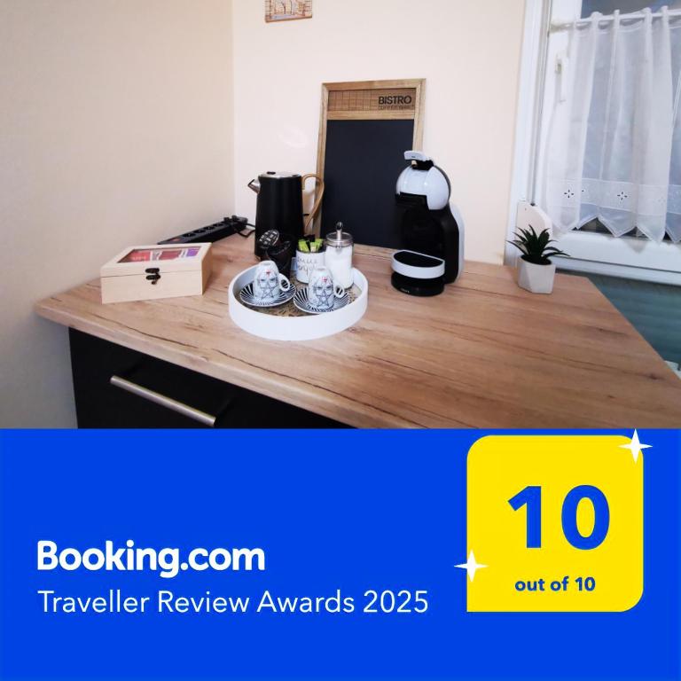 a wooden counter top with a coffee maker and cups on it at Central Park Apartman in Szekszárd
